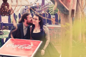 man kissing woman, at the coca cola table