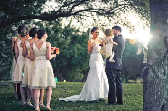 flower girl reaching out for the bride and bridesmaid waiting
