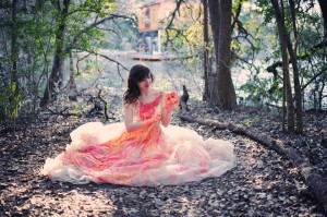 bride sitting with dress that is full of paint around her