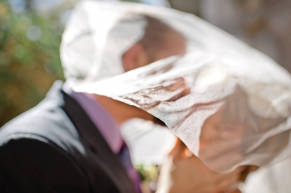 bride and groom under the veil