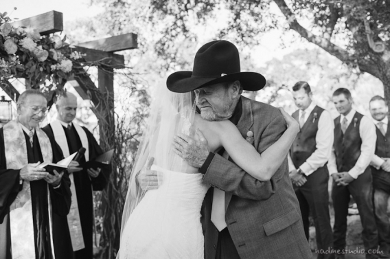 bride and father of the bride hugging
