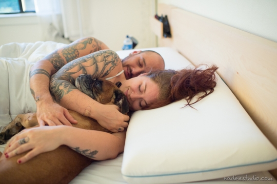 boxer dog in bed with owners