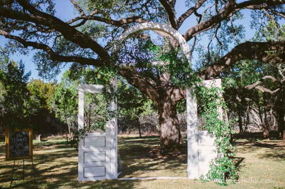 ceremony at rustic ranch two wooden doors with ivy