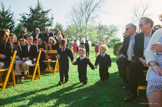 three toddlers and children walking down the ceremony aisle