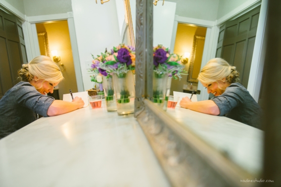 the bride writing a card to the groom