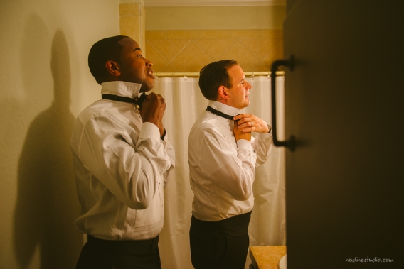 tying bowties during a wedding