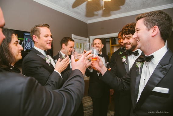 groomsmen cheering a toast