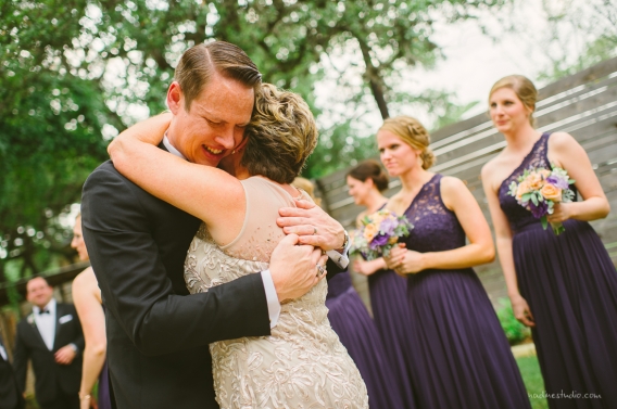 groom hugging mother of the bride