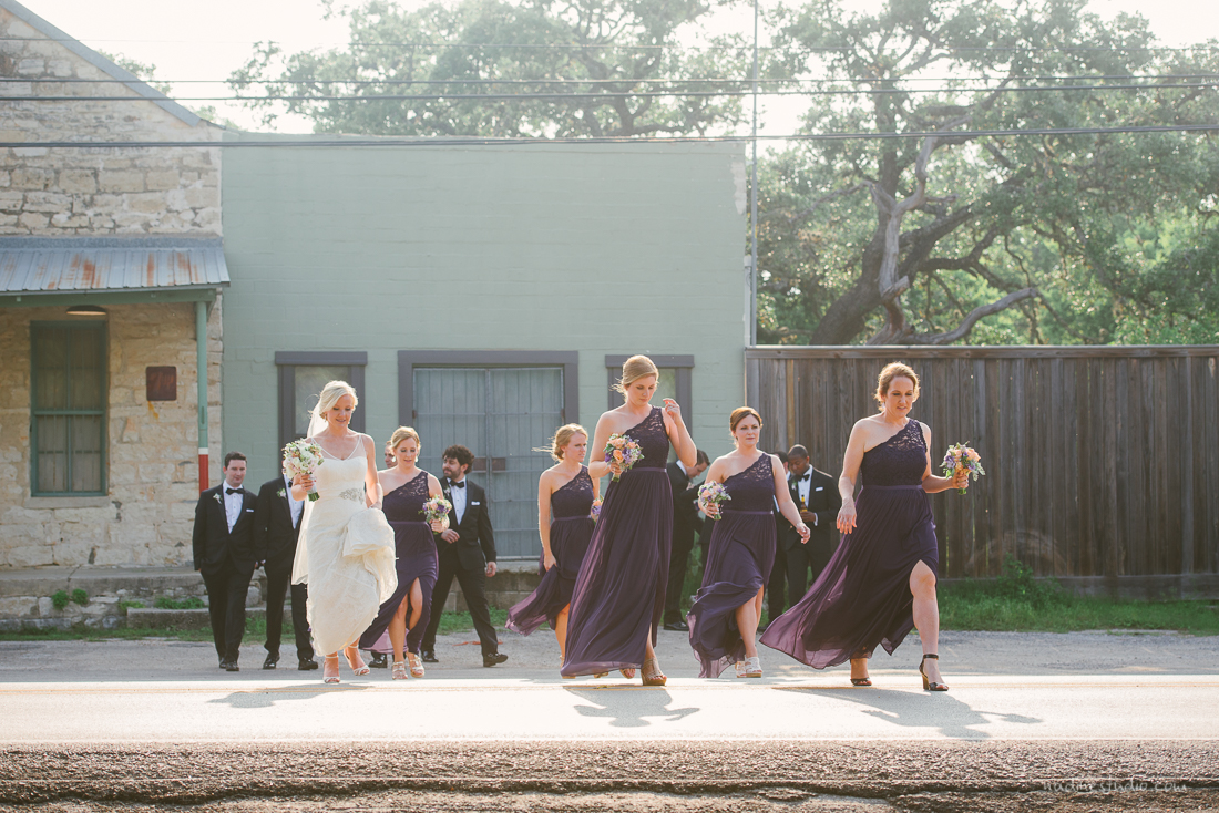 bridesmaids and groomsmen crossing the street in driftwood