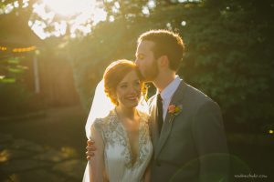 groom kissing bride in the forehead