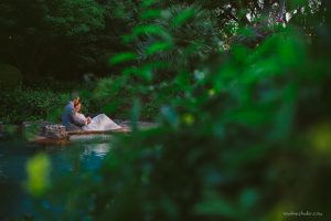 portraits by an emerald blue pool