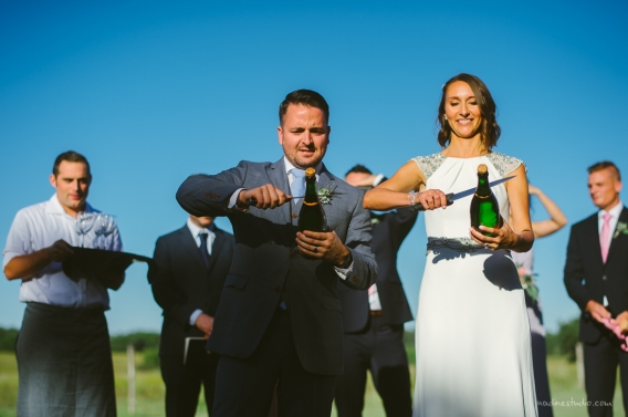 bride and groom sabering champagne