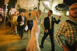 bride and groom doing the second line at a wedding mardi gras style parade