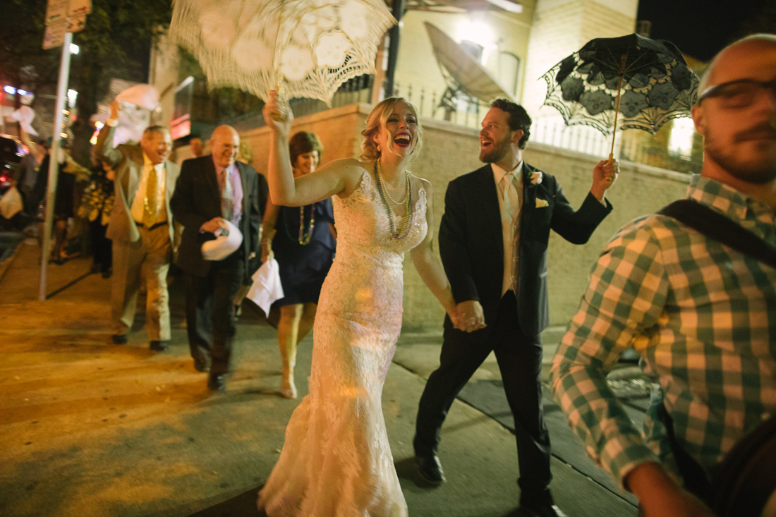 bride and groom doing the second line at a wedding mardi gras style parade