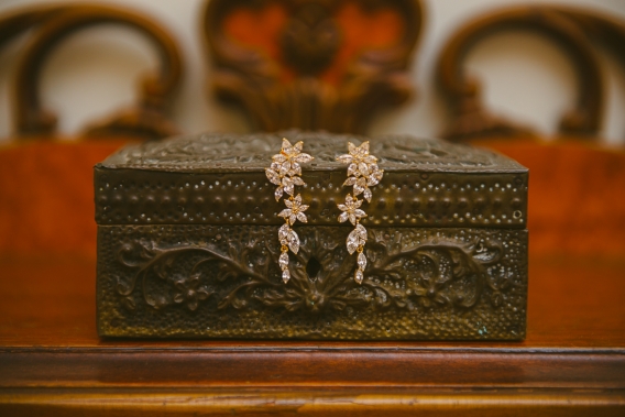 bridal earrings on a wooden chest