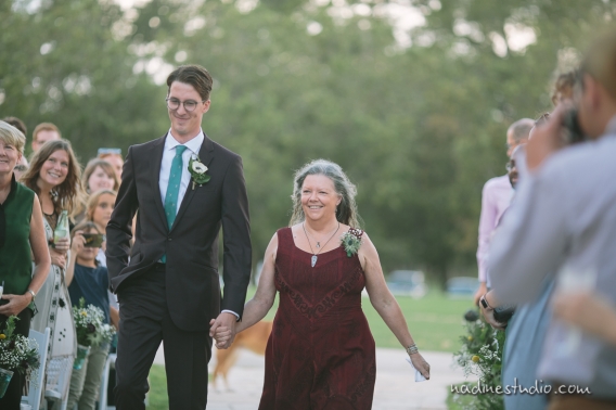 bride and mom walking down the aisle