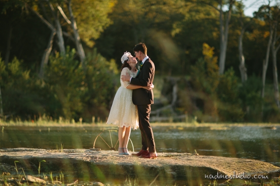 bride and groom and a small waterfall in wimberly texas
